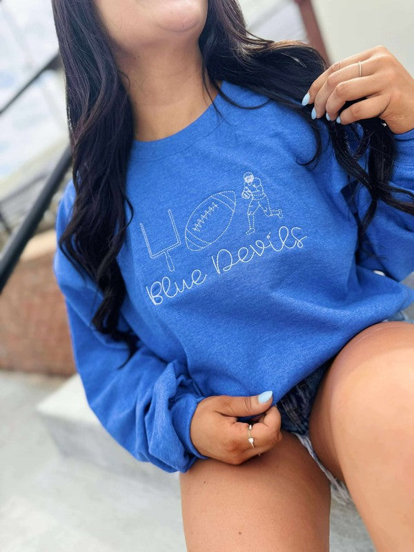 Person wearing a blue sweatshirt with 'Blue Devils' text and logo.